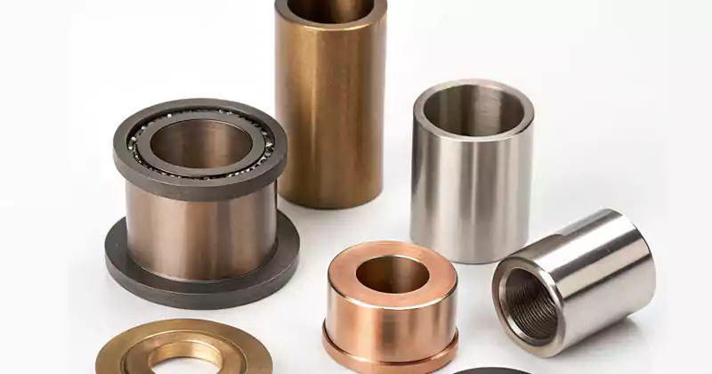 A selection of different metal and plastic bushings, including sleeve and flange types