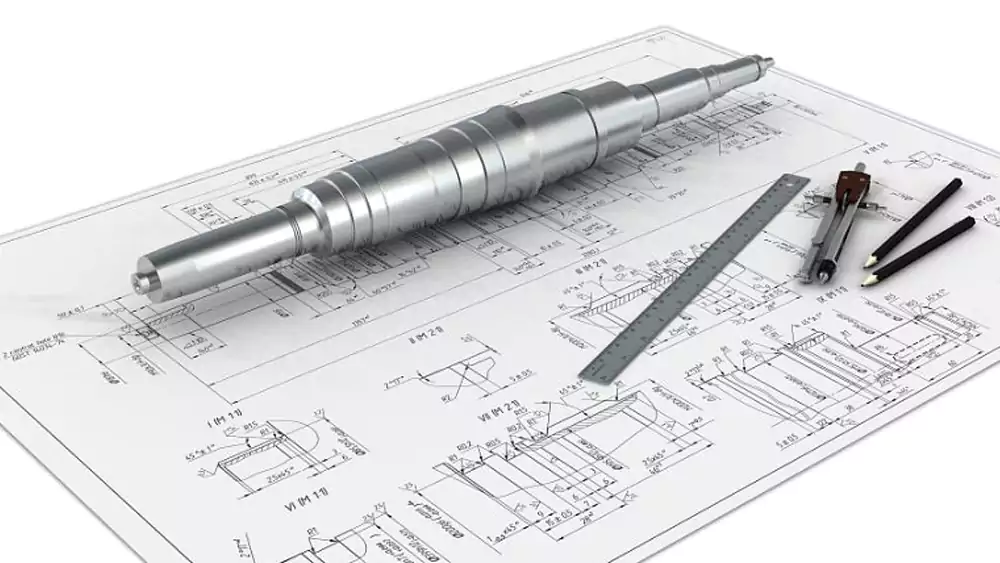 Engineer reviewing CNC shaft design and tolerance drawings